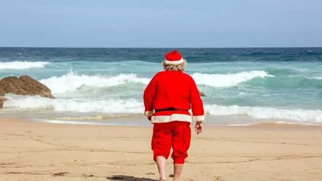 Papá Noel andando por una playa en Australia. (Foto: Unsplash)